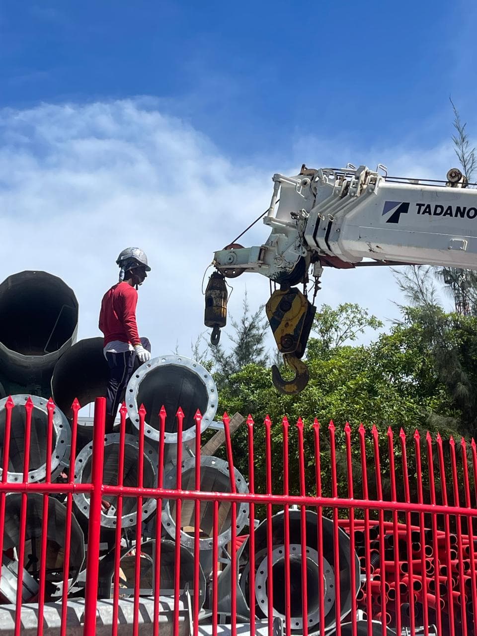 Crane lifting materials on a Rishthaa construction site