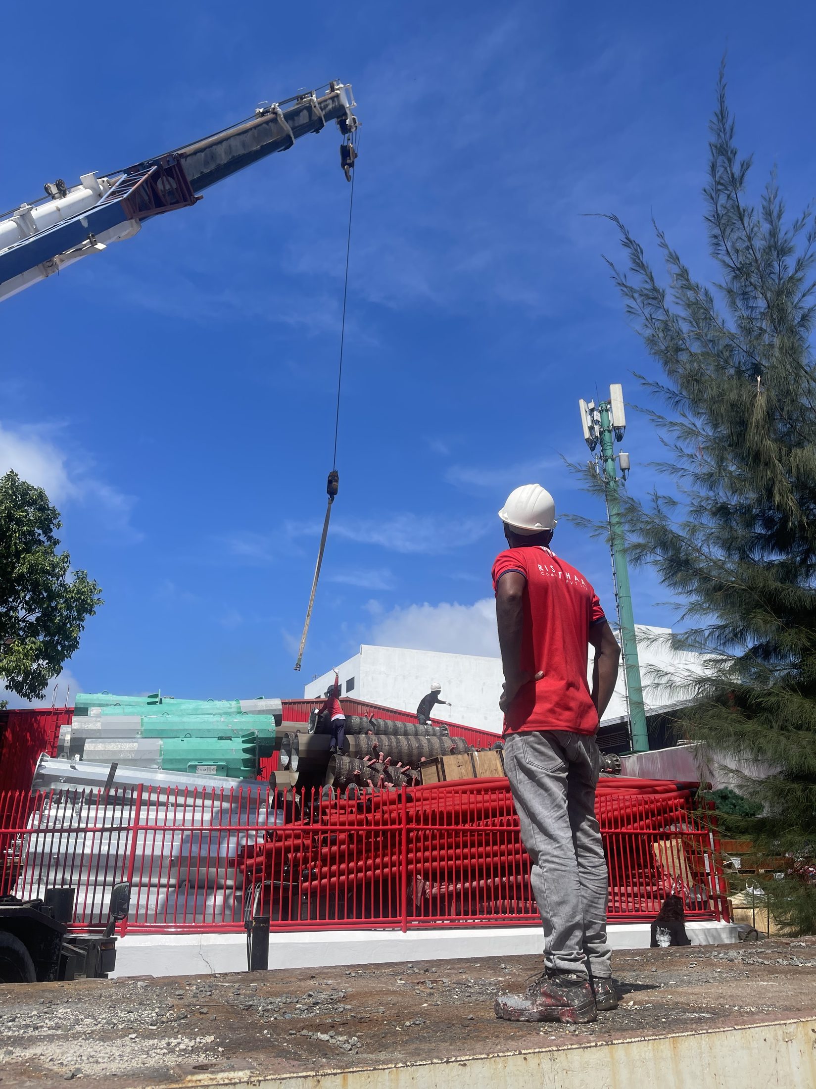 Rishthaa crew mobilising a crane and tower materials on site
